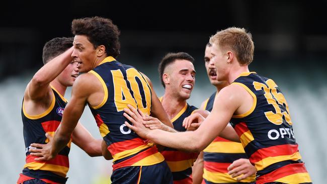 Adelaide players celebrate a goal in Round 1.