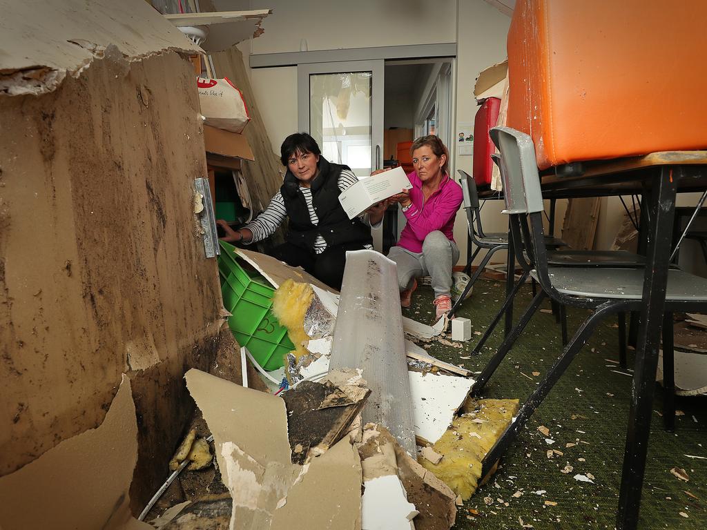 St Aloysius Primary School in Kingston remains closed Teachers Andrea Watt, left, and Jacynth Cornish clean up in the grade 2 learning pod. Picture: SAM ROSEWARNE