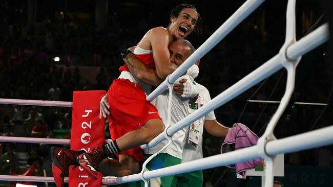 Imane Khelif celebrates after defeating China’s Yang Liu to win gold on August 9, 2024. (Photo by MOHD RASFAN / AFP)