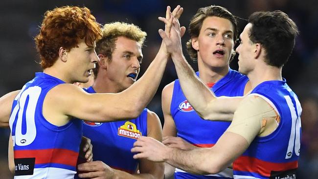 Ed Richards (left) is congratulated by teammates after kicking a goal against Geelong. Picture: Getty Images