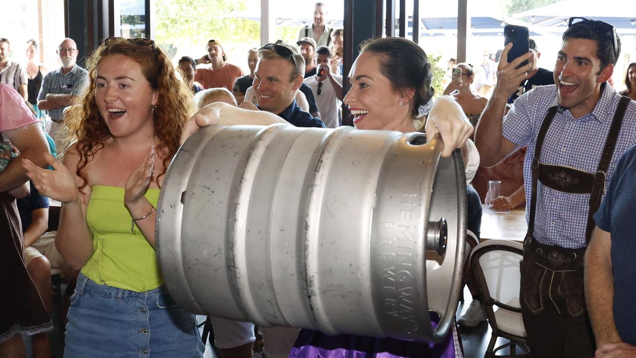 Abi Hughes encourages Renee Donald to hang on in the keg lifting competition at Hemingway's Brewery's Oktoberfest celebrations. Picture: Brendan Radke