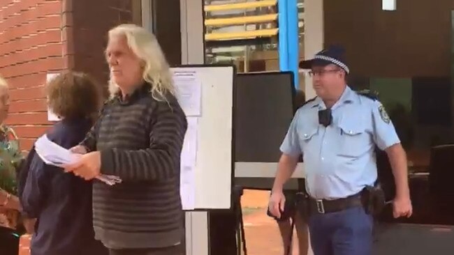 John Anderson being escorted from the Byron Shire Council chambers in Mullumbimby during the April 2021 ordinary meeting. Picture: Liana Boss