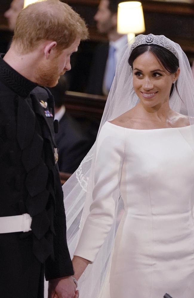 The happy couple get their hands clasped throughout the ceremony. (Dominic Lipinksi/pool photo via AP)