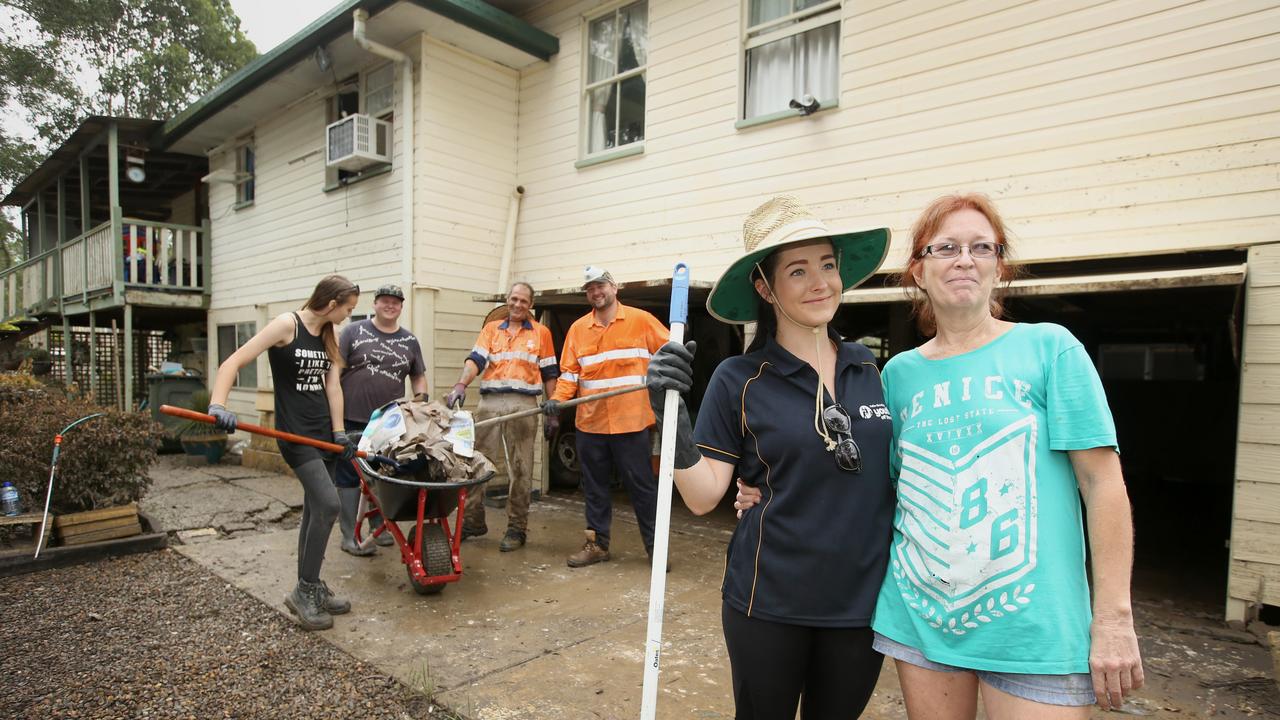 Front at right, Cortnie Wyley with effected homeowner Mary Ellen Ferguson in Logan.