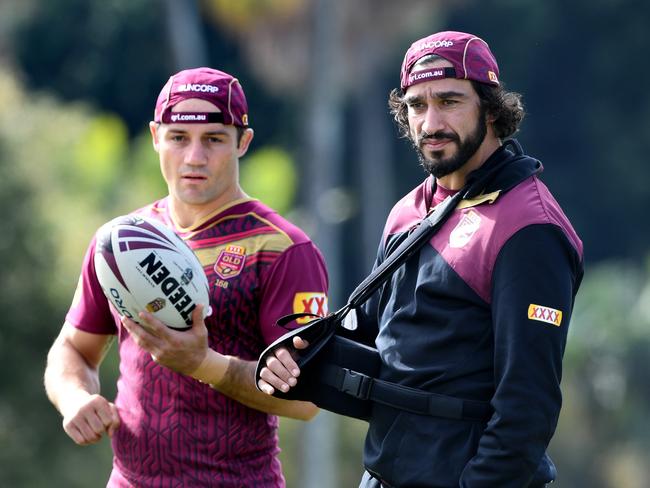 Cooper Cronk and Johnathan Thurston during a Queensland training session.