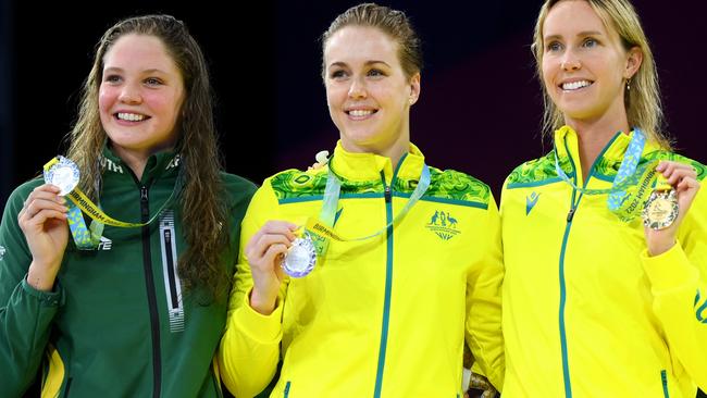 Emma McKeon flashes yet another gold medal alongside Australian teammate Holly Barratt and south Africa’s Erin Gallagher. Picture: Shaun Botterill/Getty Images