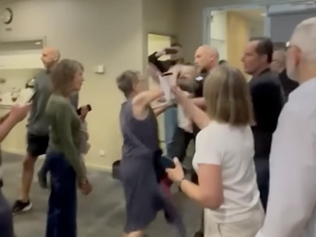 A woman hits Matt Trihey after he gatecrashes a candidates’ forum. Picture: TikTok