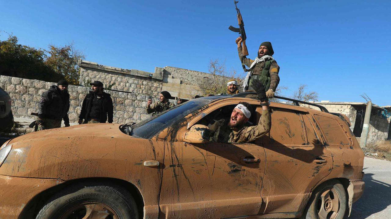 Anti-government fighters celebrate in a street in Maaret al-Numan in Syria's northwestern Idlib province. Picture: AFP