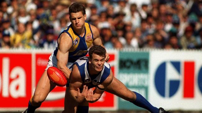 Wayne Carey marks in front of Glen Jakovich during Kangaroo's victory at MCG in 1995.