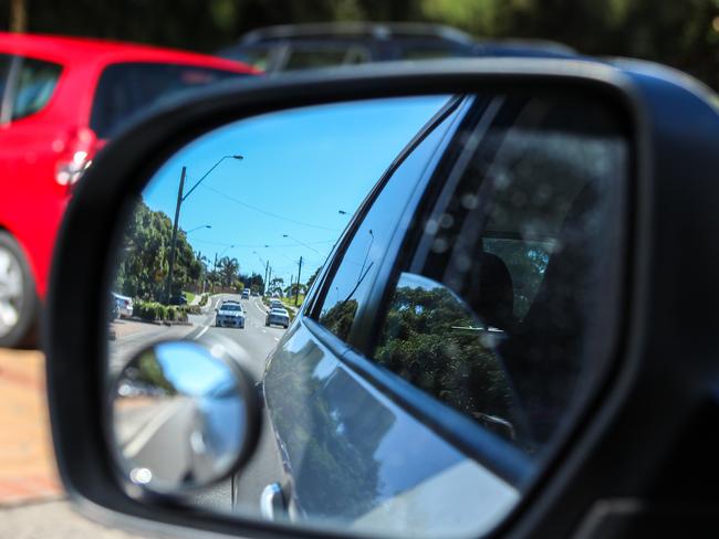 A shot on the side mirror showing a police car behind.