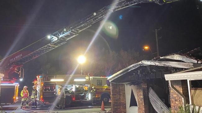 Fireys use a new aerial pumping truck which had to come from Wishart at the fire at Mt Warren Park on Monday night.