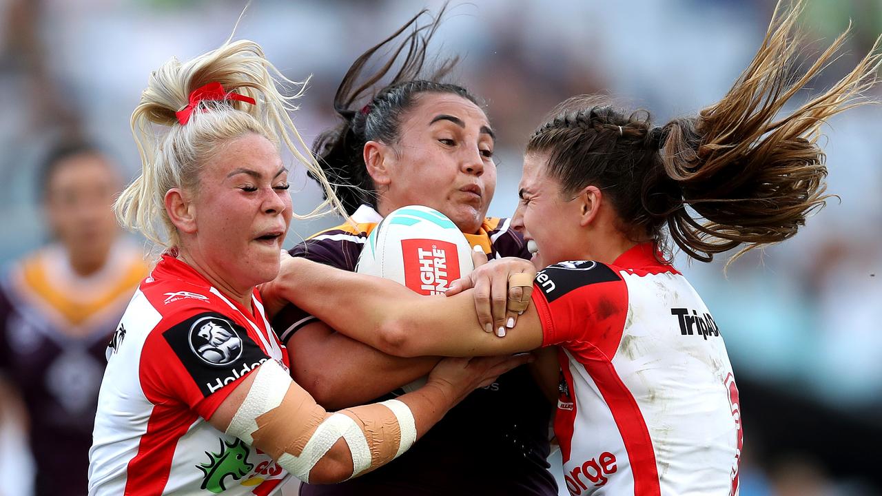 Broncos Annette Brander is tackled by Dragons Keeley Davis and Jessica Sergis during the NRLW Grand Final between the St George Illawarra Dragons and Brisbane Broncos.