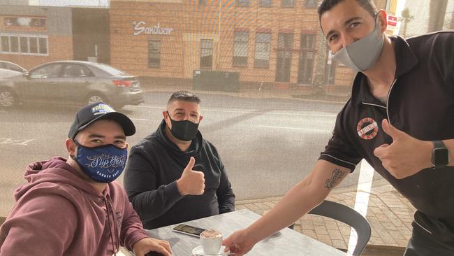 Anthony and Vince Calvi prepare for breakfast and a coffee at Kaffenio cafe in Mildura, served by manager Chris Kimerlis. Picture: Michael DiFabrizio