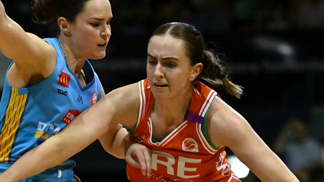 TOWNSVILLE, AUSTRALIA - NOVEMBER 16: Courtney Woods of the Townsville Fire gets past Kelly Wilson of the Spirit during the round three WNBL match between Townsville Fire and Bendigo Spirit at Townsville Entertainment Centre, on November 16, 2024, in Townsville, Australia. (Photo by Albert Perez/Getty Images)