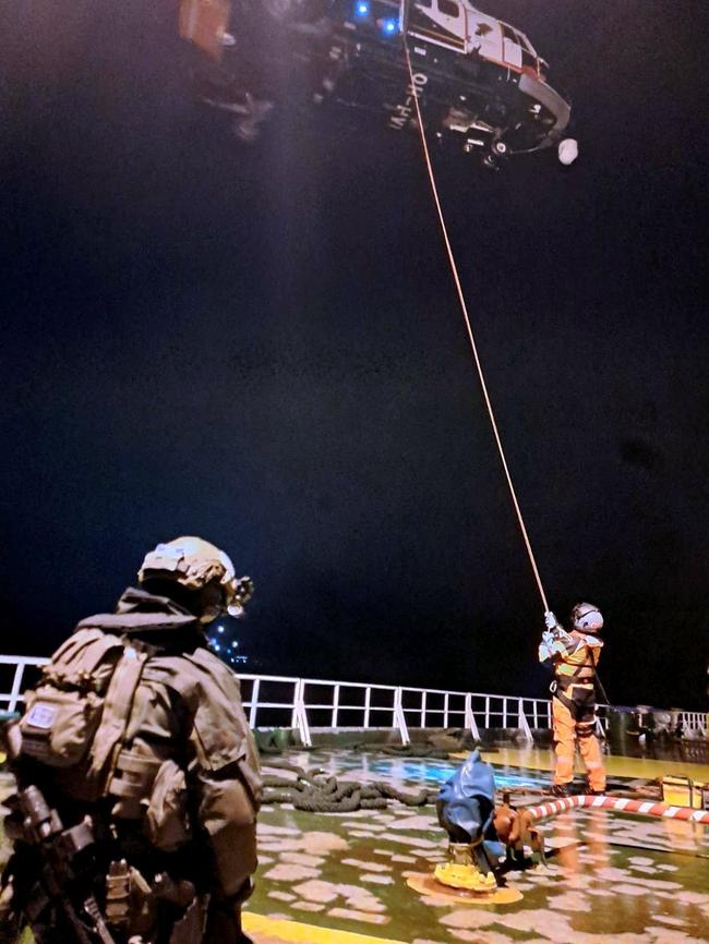 Two Finnish officials on the deck of the oil tanker, which was investigated under suspicion of “sabotage.” Picture: AFP/Finnish Border Guard