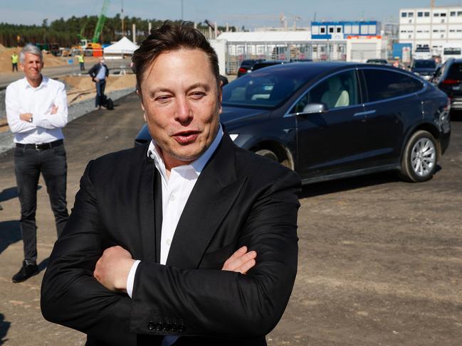 Tesla CEO Elon Musk talks to media as he arrives to visit the construction site of the future US electric car giant Tesla, on September 03, 2020 in Gruenheide near Berlin. - Tesla builds a compound at the site in Gruenheide in Brandenburg for its first European "Gigafactory" near Berlin. (Photo by Odd ANDERSEN / AFP)