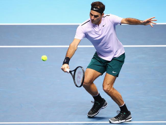 Roger Federer volleys against Marin Cilic.