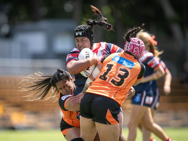 Phoenix Lamese is tackled by Claudia Brown. Picture: Julian Andrews