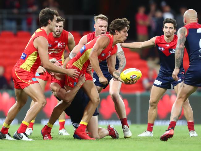 Sean Lemmens of the Suns handballs during the round eight AFL match between the Gold Coast Suns and the Melbourne Demons at Metricon Stadium on May 11, 2019 in Gold Coast, Australia. (Photo by Chris Hyde/Getty Images)