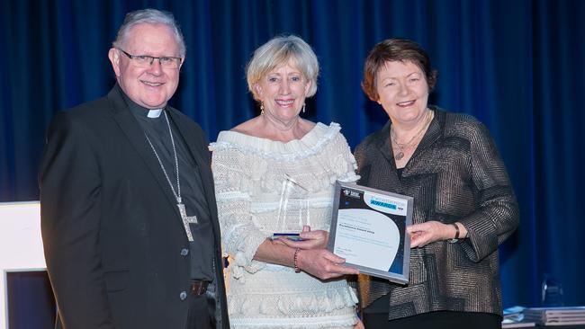 Archbishop Mark Coleridge and Brisbane Catholic Education Executive Director Pam Betts present Seton College teacher Kathryn Flint one of the top honours at the Excellence in Learning in Teaching in a Secondary School awards last year.