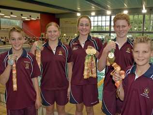 MEDAL MAESTROS: Toowoomba Grammar School Swim Club members (from left) Cooper Harm, Isabelle Mason, Abby Schoorl, Henry Reardon and Bailey Harm celebrate their success at the Australian Schools Swimming Championships. Picture: Jason Gibbs