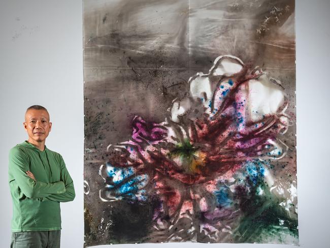 Contemporary artist Cai Guo-Qiang with his new 31m gunpowder painting, Transience II (Peony). Picture: Jason Edwards