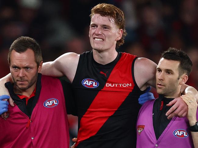 MELBOURNE, AUSTRALIA - MAY 10: Lewis Hayes of the Bombers reacts to an injury during the round nine AFL match between Essendon Bombers and Sydney Swans at Marvel Stadium, on May 10, 2025, in Melbourne, Australia. (Photo by Morgan Hancock/Getty Images)