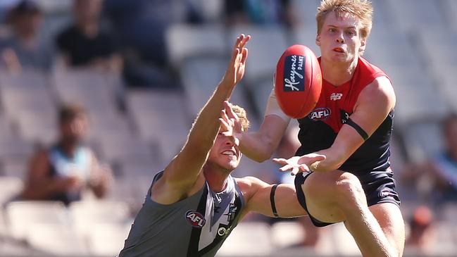 Port Adelaide’s Jack Watts pressures Melbourne’s Charlie Spargo during the round one AFL match at Melbourne Cricket Ground. Picture: by Michael Dodge/Getty.