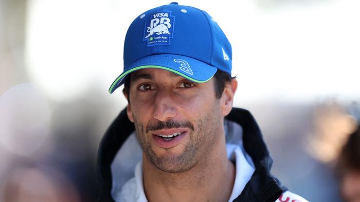 CORRECTION / RB's Australian driver Daniel Ricciardo arrives to the paddocks at the Albert Park Circuit ahead of the Formula One Australian Grand Prix in Melbourne on March 21, 2024. (Photo by Martin KEEP / AFP) / -- IMAGE RESTRICTED TO EDITORIAL USE - STRICTLY NO COMMERCIAL USE -- / â€œThe erroneous mention[s] appearing in the metadata of this photo by Martin KEEP has been modified in AFP systems in the following manner: [RB's Australian driver Daniel Ricciardo] instead of [SIC58 Squadra Corse's Italian rider Riccardo Rossi arrives]. Please immediately remove the erroneous mention[s] from all your online services and delete it (them) from your servers. If you have been authorized by AFP to distribute it (them) to third parties, please ensure that the same actions are carried out by them. Failure to promptly comply with these instructions will entail liability on your part for any continued or post notification usage. Therefore we thank you very much for all your attention and prompt action. We are sorry for the inconvenience this notification may cause and remain at your disposal for any further information you may require.â€