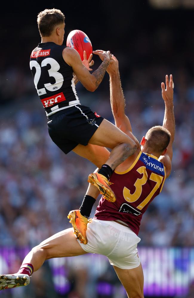 Bobby Hill flies over Brandon Starcevich. Picture: Michael Willson/AFL Photos via Getty Images