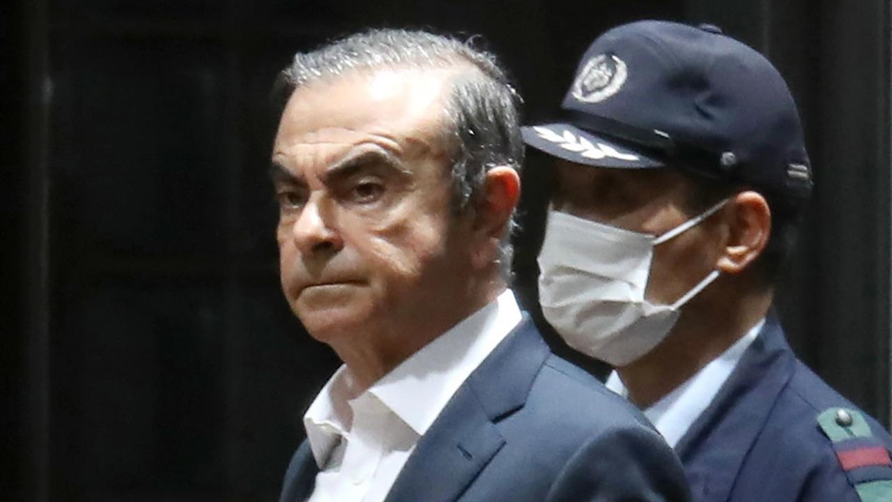 This file photo taken on April 25, 2019 shows Ghosn being escorted from the Tokyo Detention House following his release on bail in Tokyo. Picture: AFP.