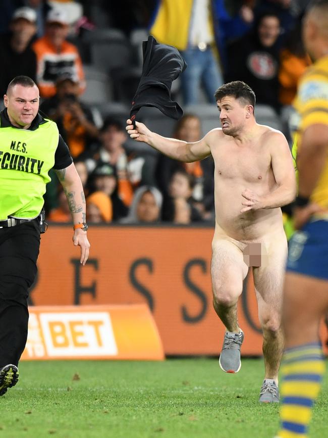 Matthew Cooper streaks on to the field during the Wests Tigers and Parramatta Eels game. Picture: AAP/Joel Carrett