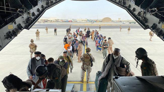 Spaniards as well as Afghans and their families who worked at the Spanish side, queue to board the first Spanish Air Force Airbus A400M headed to Dubai from the Kabul airport. Picture: AFP