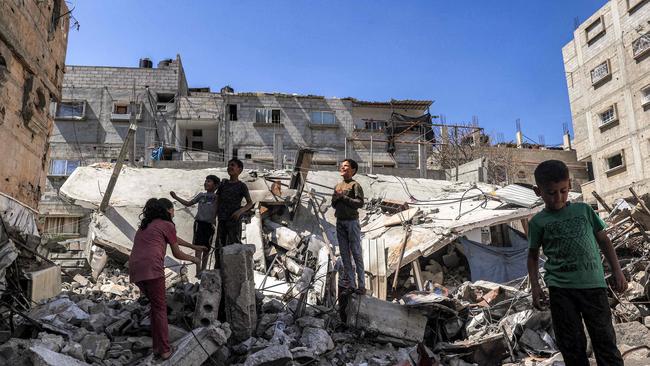 Children play in the rubble in Rafah on Tuesday. Picture: AFP