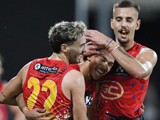 Izak Rankine, Malcolm Rosas and Joel Jeffrey of the Suns celebrate a goal during the 2022 AFL Round 11 match between the Gold Coast Suns and the Hawthorn Hawks at TIO Stadium on May 28, 2022 in Darwin, Australia. Picture: Felicity Elliott/AFL Photos