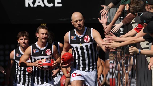 Magpies players run onto the field during the SANFL elimination final. Picture: David Mariuz