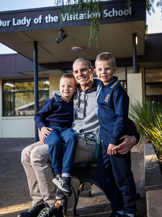 Matt Dyda with sons Milo, 5, Logan, 7, are pleased that Catholic schools are freezing fees for 2023. Picture: Tom Huntley