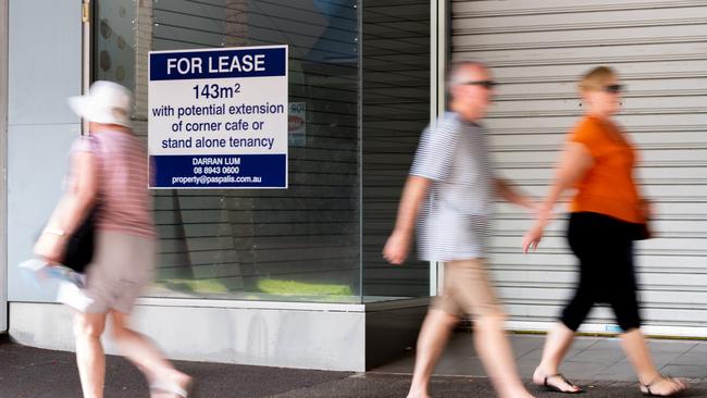 Shoppers walk past empty storefronts in Darwin's Smith Street Mall. Picture: Che Chorley