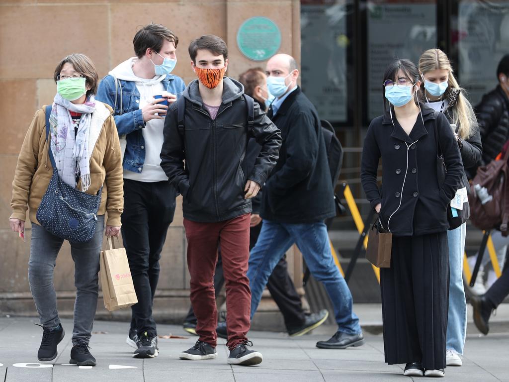 People masking up in Sydney as new restrictions are brought in. Picture: John Grainger