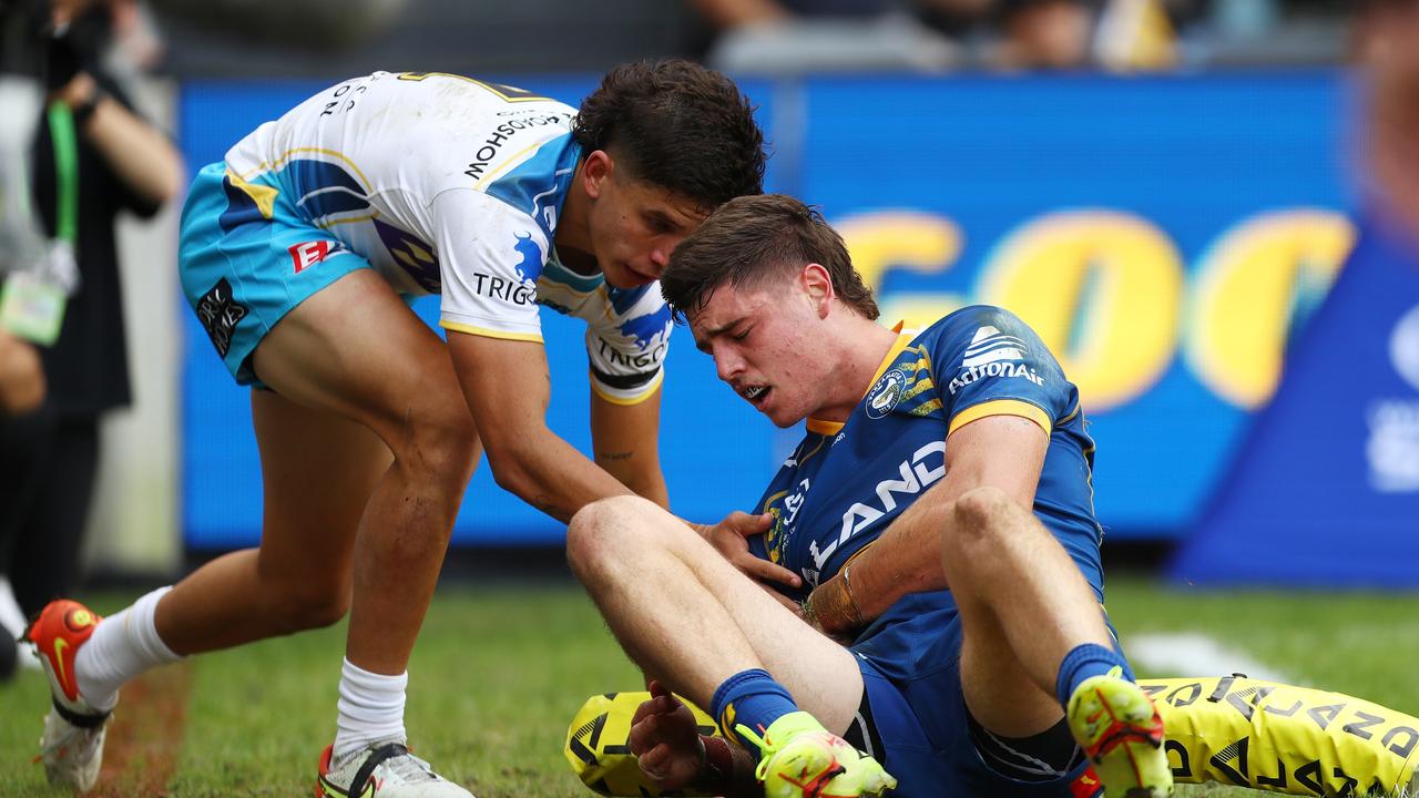 Sean Russell grabs at his ribs after collisions with Jayden Campbell. Picture: Mark Metcalfe/Getty