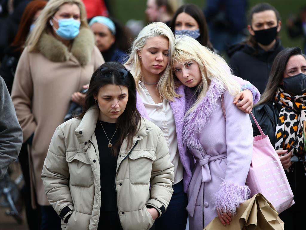 Two women embrace as they pay their respects on Clapham Common, where floral tributes have been placed for Sarah Everard in London, England. Picture: Hollie Adams/Getty Images)