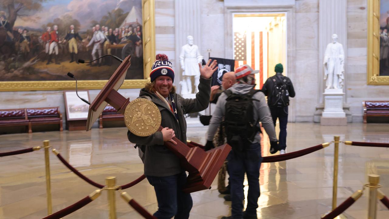 Adam Johnson, seen here carrying Nancy Pelosi’s lectern, has also been arrested. Picture: Getty Images