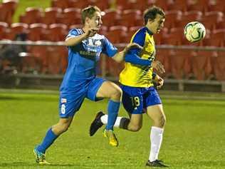 UNDER PRESSURE: South West Queensland Thunder captain Jacob Bigby (left) battles for control against his Brisbane Strikers opponent. The Thunder face Olympic FC on Saturday. Picture: Kevin Farmer