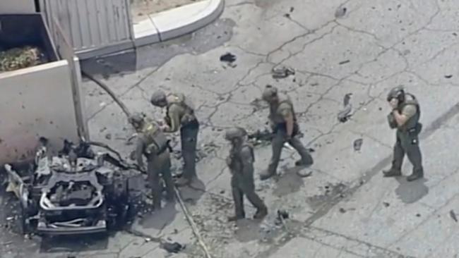 Law enforcement investigate a vehicle after an explosion on Saturday, May 17, 2025 in Palm Springs, Calif.  (ABC7 Los Angeles via AP)