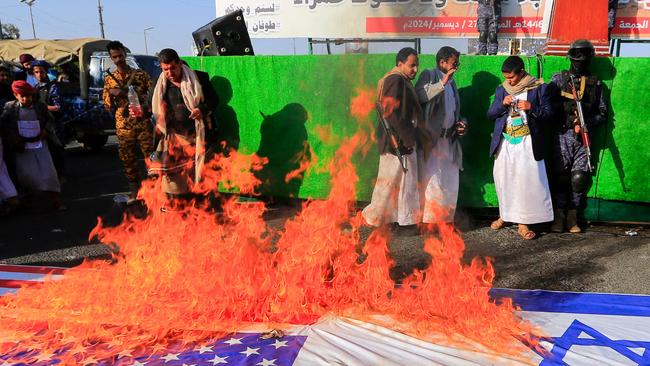 Yemenis set fire to US and Israeli flags in Sana’a. Picture: AFP