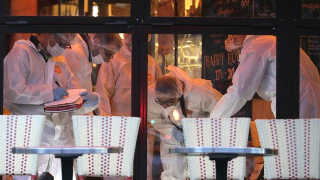 Investigations underway ... Forensic police search for evidences inside the Comptoir Voltaire cafe at the site of an attack. Picture: AFP/Kenzo Tribouillard