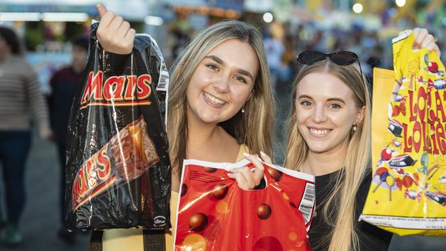 Brisbane visitors Kimmy Balmer (left) and Allana Acton with show bags at the Toowoomba Royal Show, Thursday, March 30, 2023. Picture: Kevin Farmer