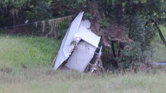 A shed is left in the middle of a field after being destroyed by flash flooding. A significant amount of debris was also washed into the Corindi River. Photo: Tim Jarrett