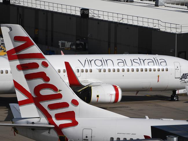 Grounded Virgin Australia planes are seen at Tullamarine Airport in Melbourne, Tuesday, April 21, 2020. Virgin Australia has gone into voluntary administration following financial pressure due to the impact of Coronavirus. (AAP Image/James Ross) NO ARCHIVING
