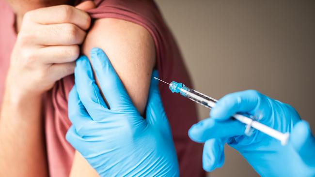 Close up of arm of boy getting vaccinated by doctor holding a needle. Getty stock image